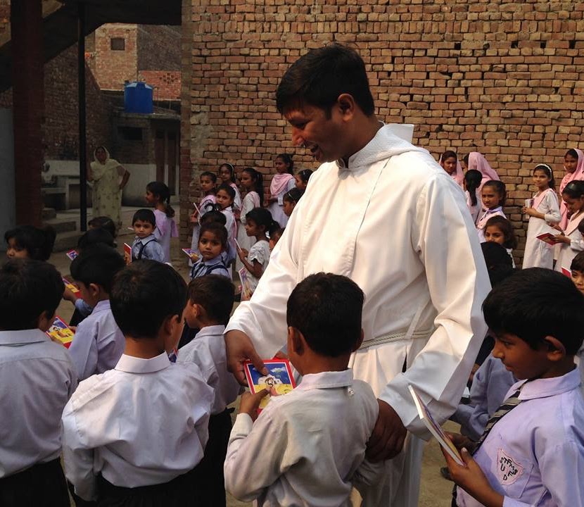 Fr. Lazar distributing to schoolchildren