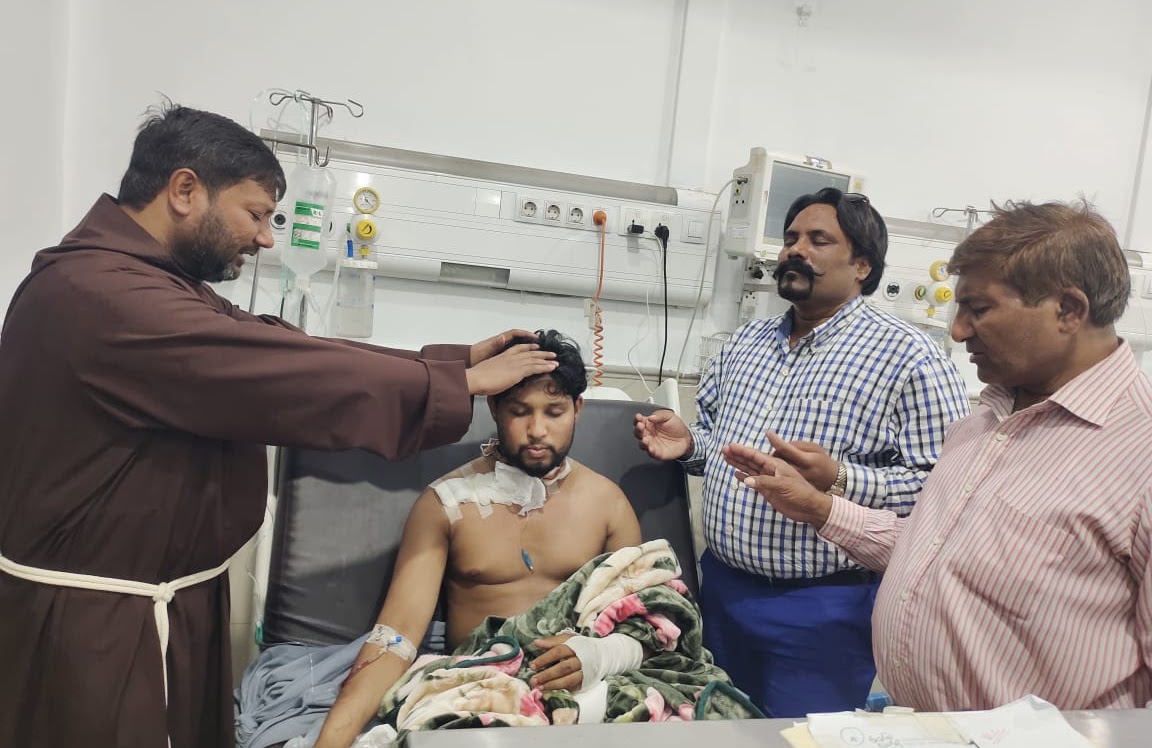 Blessing an injured man in hospital